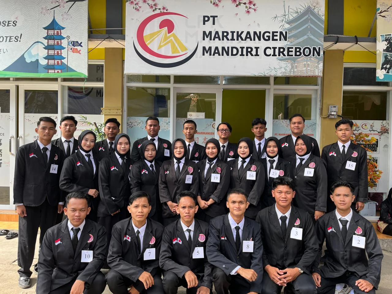 Participants in front of the company office